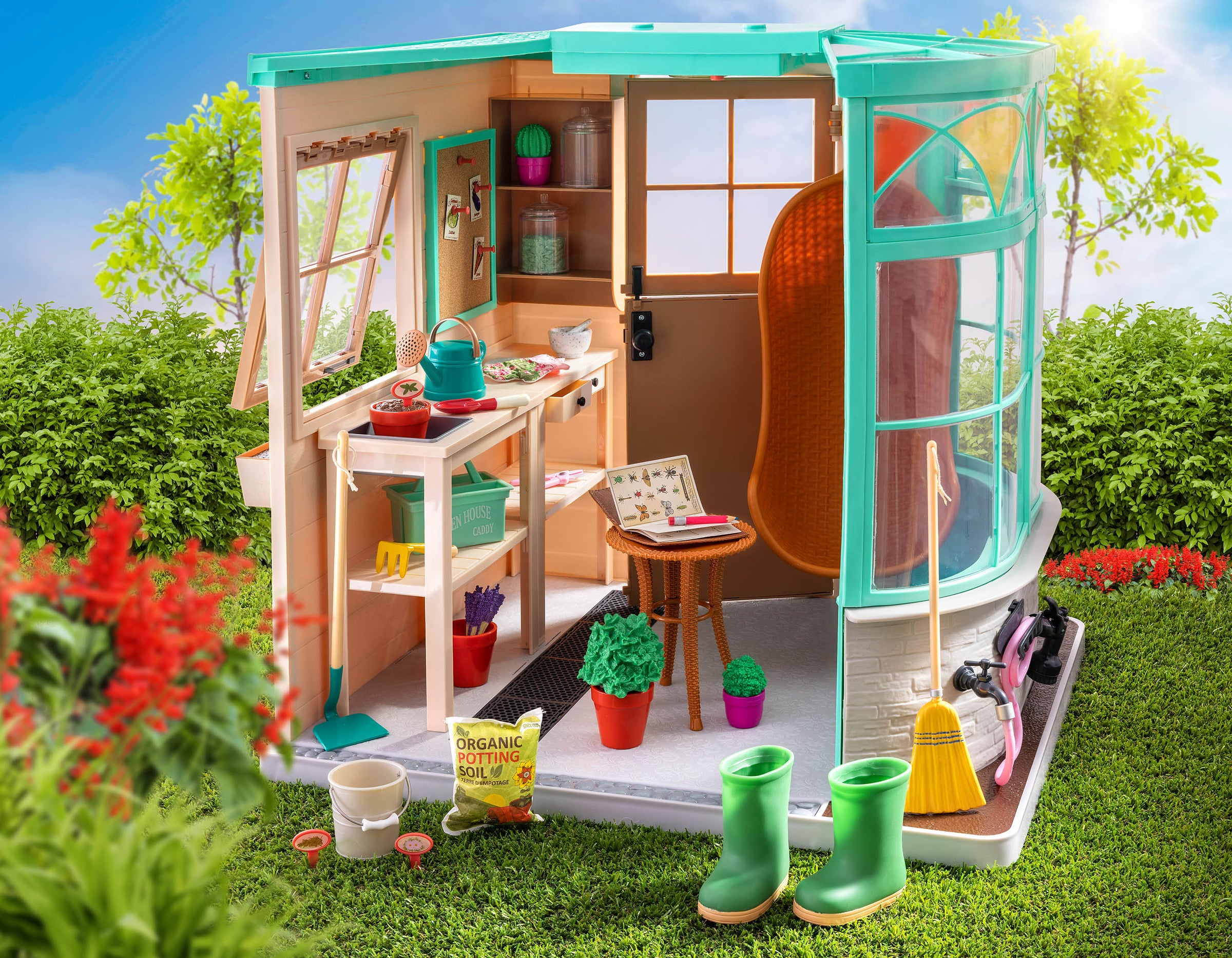 Our Generation Greenhouse is being shown, which has lots of accessories scattered around the playset. 